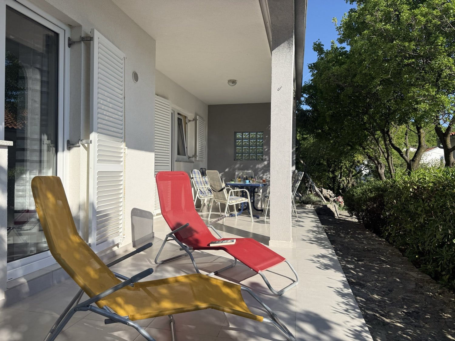 Sun loungers on the covered terrace in the shade