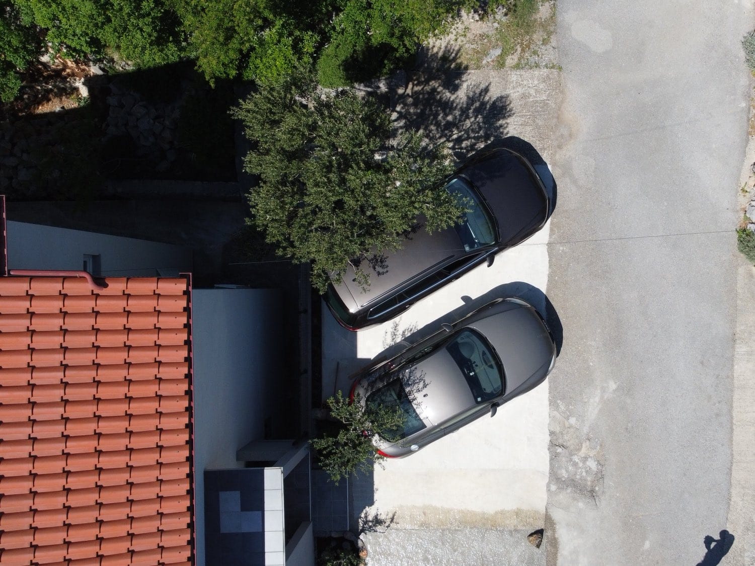 Private parking on the driveway by the house, aerial view
